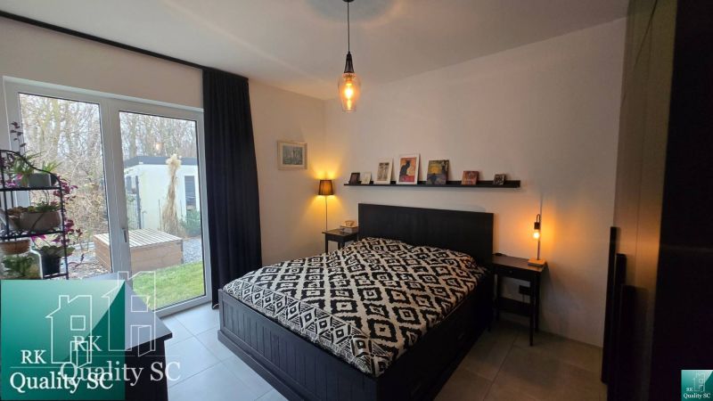 Schlafzimmer mit Bett und Dekorationen, Zugang zum Garten, Einfamilienhaus.