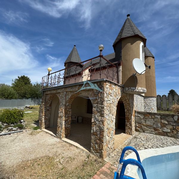Ein Haus in der Agátová-Straße in Šahy mit einer Steinfassade und einem kleinen Pool vorne.