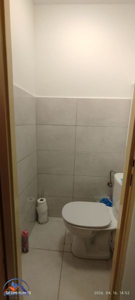 Badezimmer mit Toilette und Fliesen in einer 2-Zimmer-Wohnung.