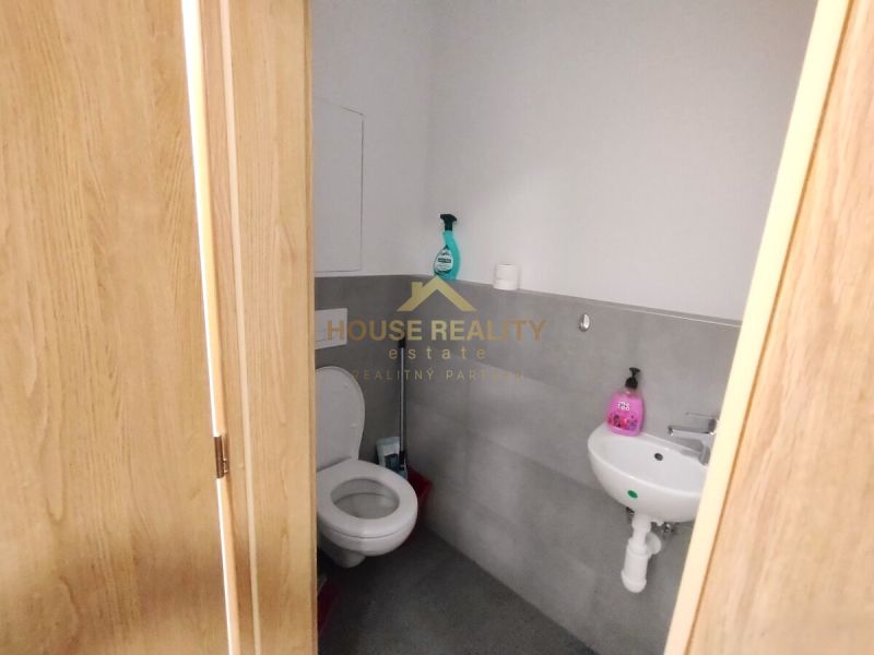 Toilette mit Waschbecken in einer 2-Zimmer-Wohnung, helle Wände und Türen mit Holzdekor.
