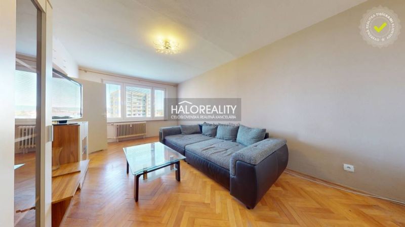 Wohnzimmer mit Sofa, Couchtisch und Holzboden in einer 2-Zimmer-Wohnung.