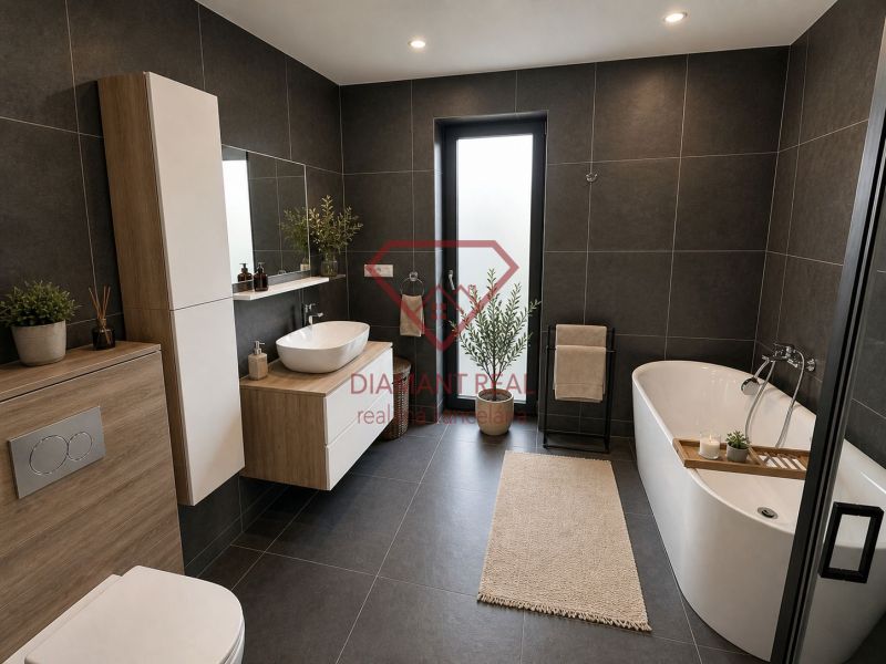 Badezimmer in einem Einfamilienhaus mit Badewanne, Waschbecken und dunklen Fliesen.