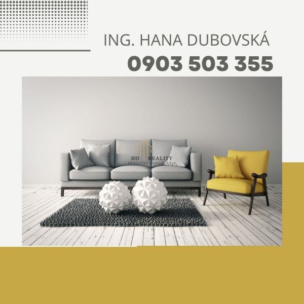 Wohnzimmer mit Sofa und Sessel, dekorative Elemente auf Holzboden.