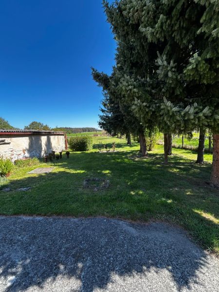 Der Garten beim Einfamilienhaus in Mikulášov in Lakšárska Nová Ves mit großen Bäumen.