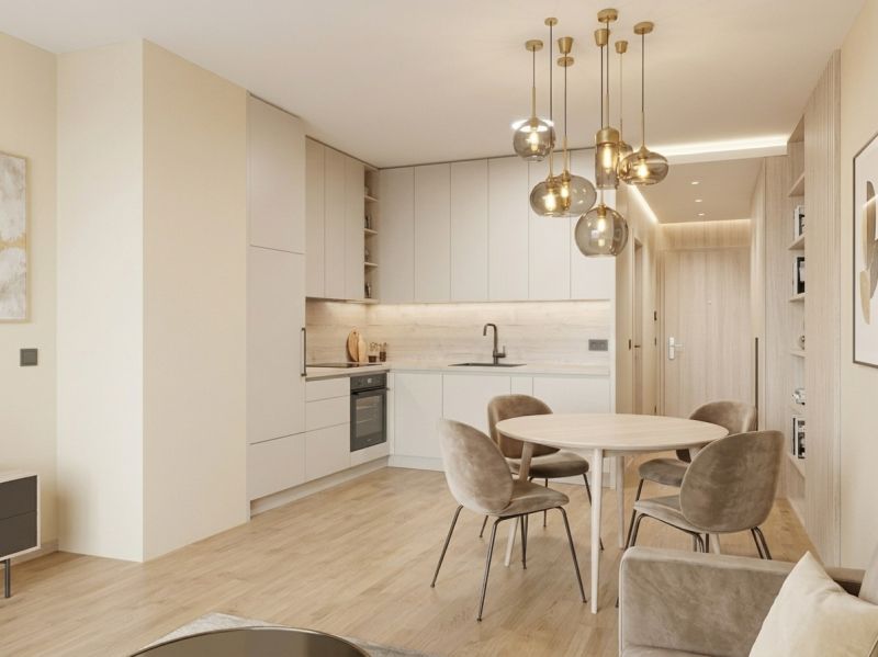 Innenraum einer 1-Zimmer-Wohnung mit Küchenzeile, rundem Tisch und Boden mit Holzdekor.