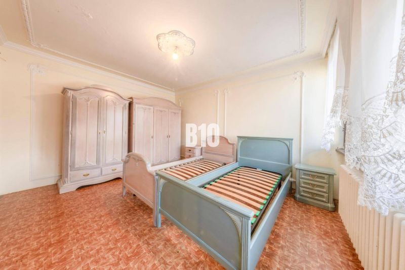 Schlafzimmer in einem Einfamilienhaus mit Holzboden, Betten und Kleiderschränken.