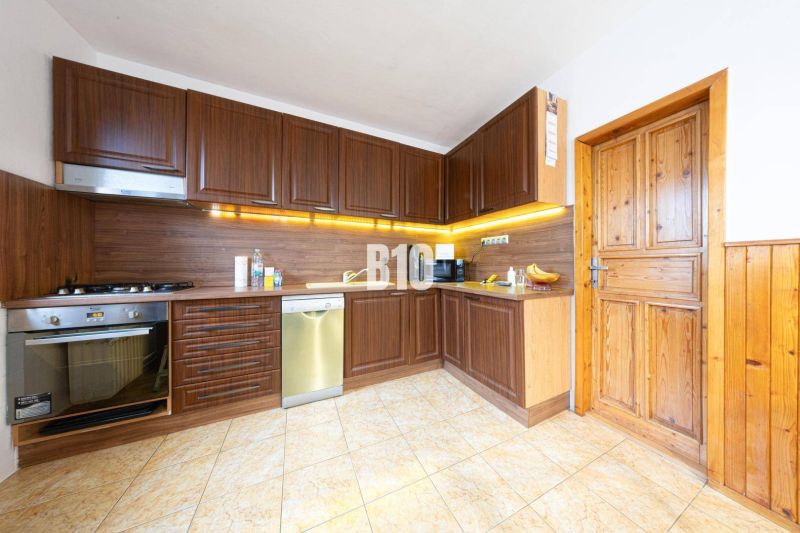 Küche mit Holzschränken, Boden mit Holzdekor in einem Einfamilienhaus.
