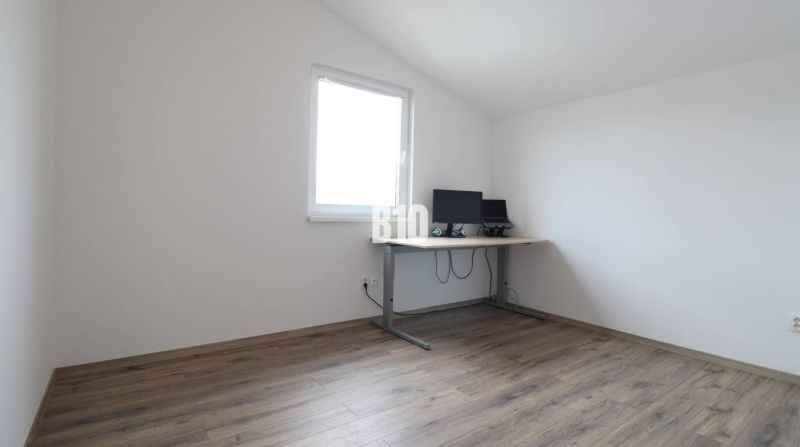 Izba in einem Einfamilienhaus mit einem Holzboden und einem Schreibtisch.