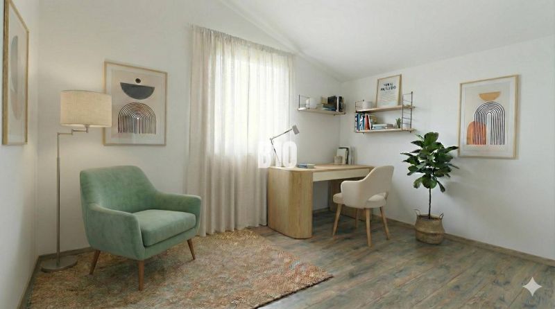 Ein Arbeitszimmer in einem Einfamilienhaus mit einem Sessel, einem Tisch und einem Boden in Holzoptik.