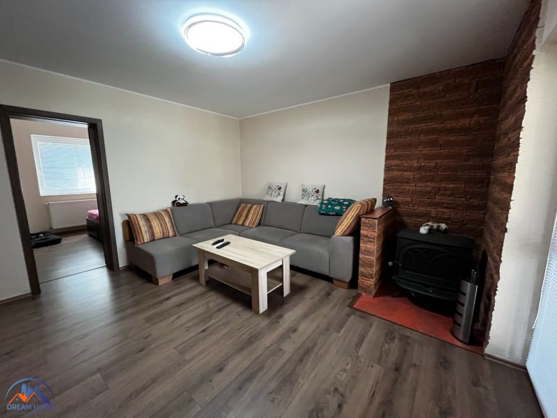 Wohnzimmer in einem Einfamilienhaus mit Holzboden und Kachelofen.
