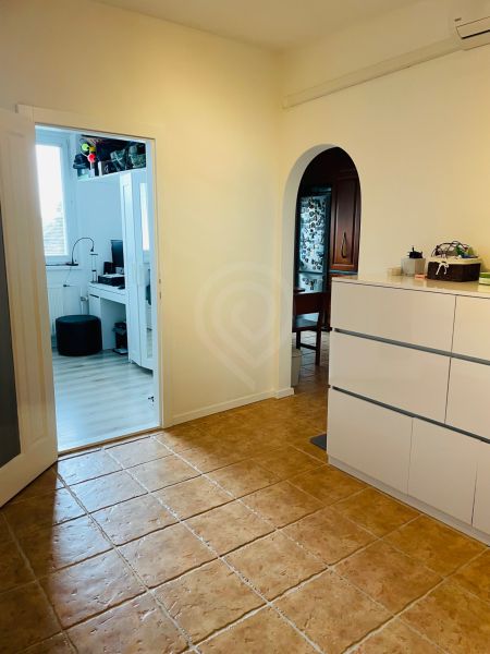 Flur mit hellem Fliesenboden und Durchgang zur Küche in einer 3-Zimmer-Wohnung.