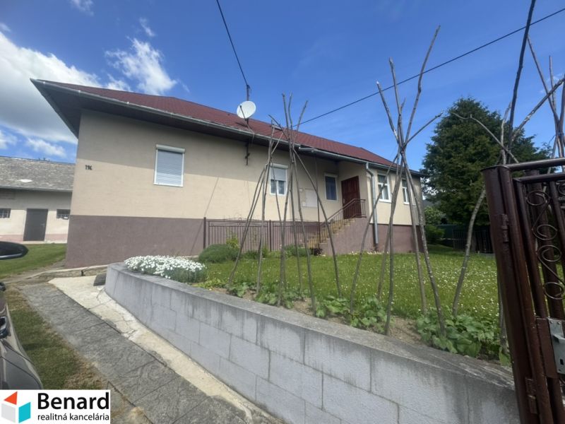 Ein Einfamilienhaus in Orlové mit rotem Dach und eingezäuntem Garten.