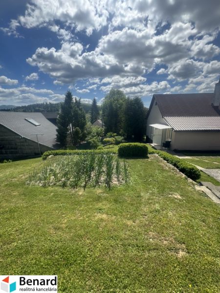 Ein Garten mit Rasen und Aussicht auf die Umgebung in Orlov bei Einfamilienhäusern.