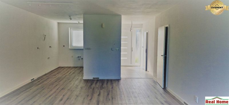 Innenraum eines Einfamilienhauses mit Holzboden und hellen Wänden.