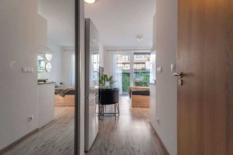Innenraum einer 1-Zimmer-Wohnung mit Holzboden und großem Fenster.