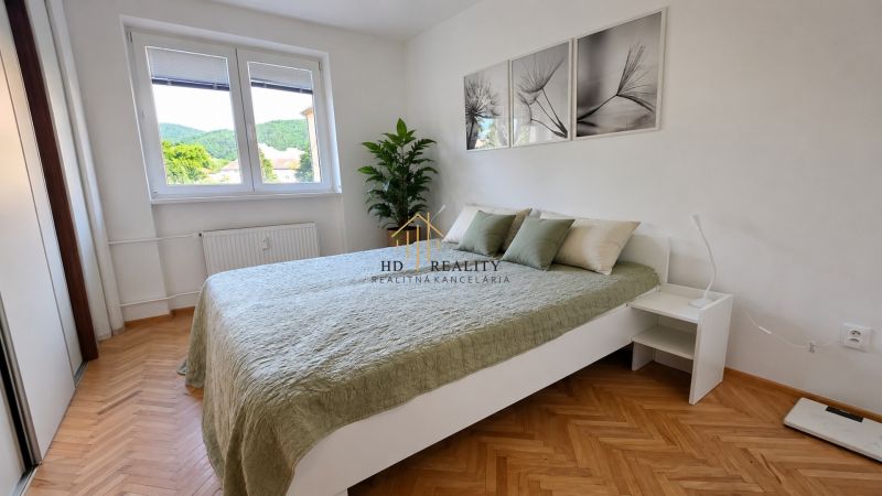 Ein Zimmer in einer 2-Zimmer-Wohnung mit Holzboden und einem großen Fenster.