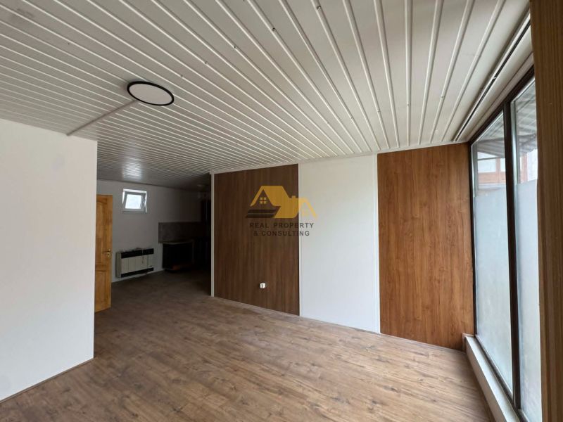 2-Zimmer-Wohnung mit Holzboden und Holzverkleidung an der Wand.