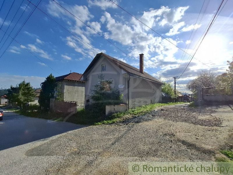 Ein Familienhaus in Šumiac mit ländlichem Charme, umgeben von Grün und einem hellblauen Himmel.