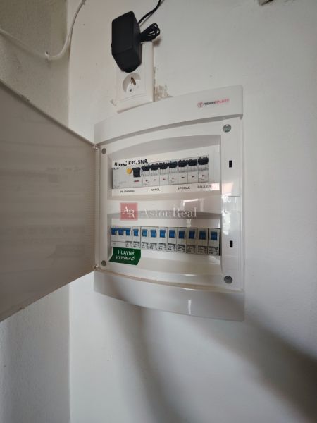 Ein elektrischer Verteilerkasten in einer 2-Zimmer-Wohnung mit offenen Türen und einer Steckdose.