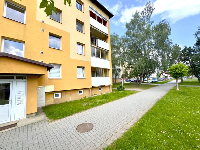 Außenbereich des Wohnhauses in Lipany mit Grünflächen, geeignet für eine 4-Zimmer-Wohnung.