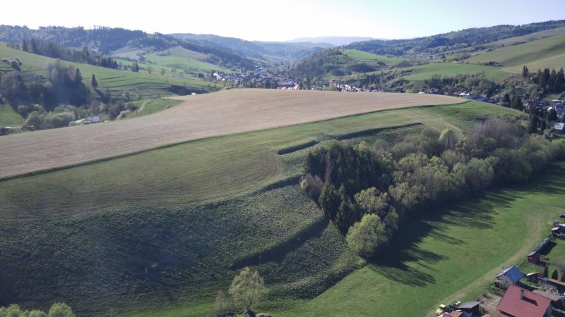Landwirtschaftliche und forstwirtschaftliche Flächen in der Umgebung von Čierny Balog mit Blick auf malerische Berge.
