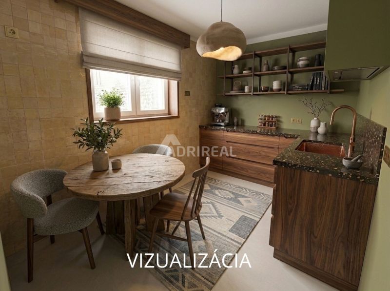 Küche in einer 2-Zimmer-Wohnung mit Holzmöbeln und rundem Tisch.