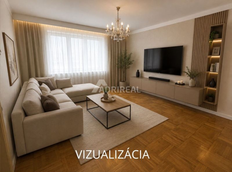 Wohnzimmer mit Ecksofa, Fernseher und Holzboden in einer 2-Zimmer-Wohnung.