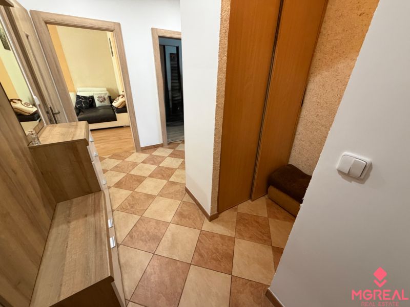 Der Flur in der 3-Zimmer-Wohnung mit Fliesen und einem Einbauschrank.