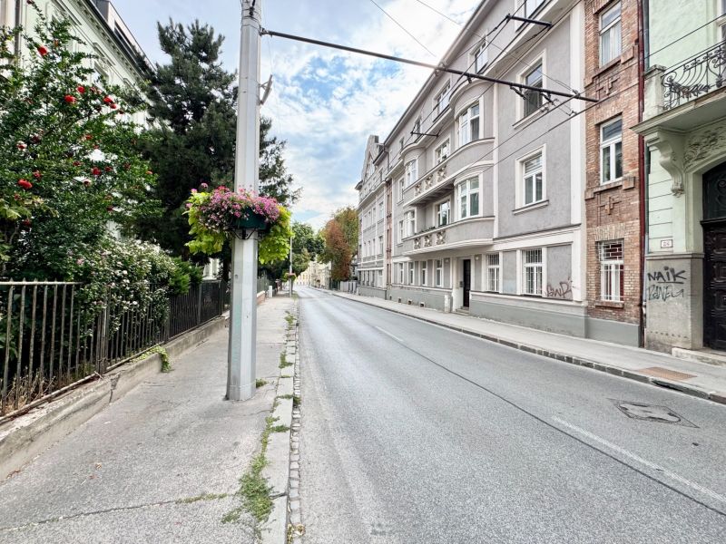 Palisaden in der Altstadt von Bratislava mit historischen Gebäuden und Blumenschmuck an der Säule.