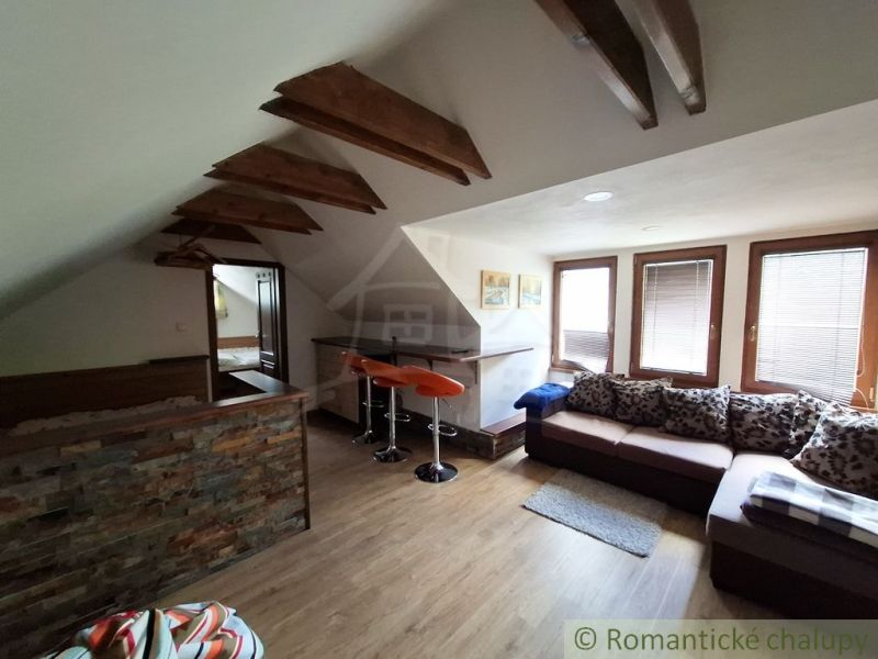 Dachgeschoss-Geschäftsräume mit Holzboden und bequemen Sitzgelegenheiten.