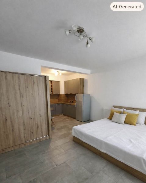 Schlafzimmer in einer Einzimmerwohnung mit Küche, Holzboden, graue Möbel.