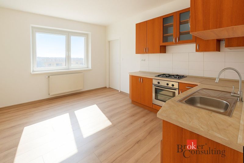 Küche mit Holzelementen und Geräten in einer 2-Zimmer-Wohnung.