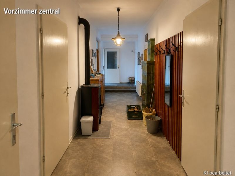 Der Flur in einem Einfamilienhaus mit einer Garderobe, einem Spiegel und einem Ofen, der Boden mit Holzdekor.