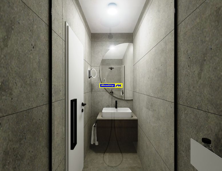 Badezimmer in einer 3-Zimmer-Wohnung mit Waschbecken, Spiegel und grauen Wänden.