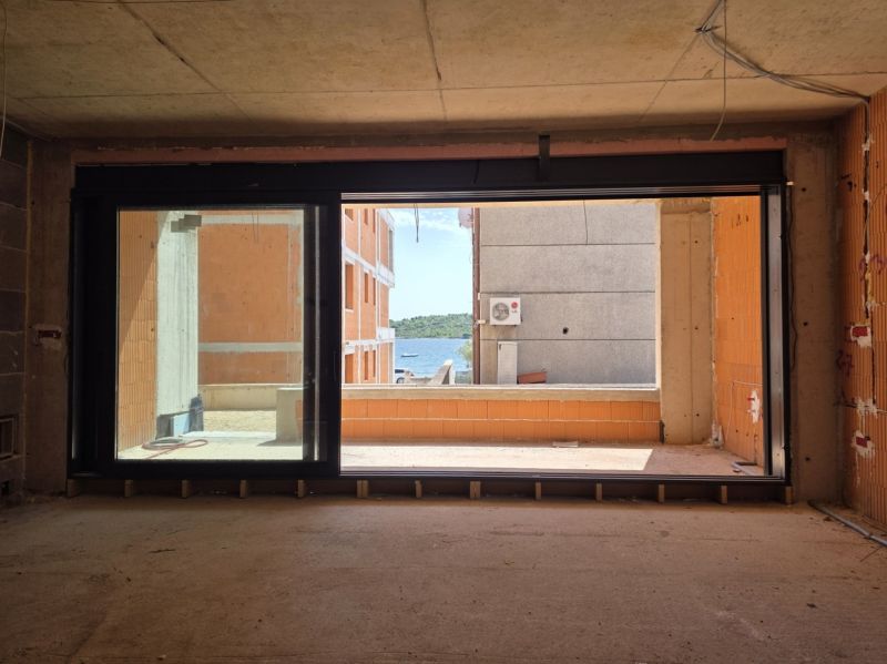 Meerblick durch ein großes Fenster in einer 3-Zimmer-Wohnung in der Stadt Srima.