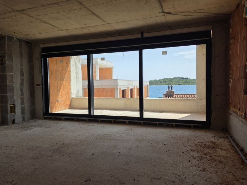 Unvollendetes Interieur einer 3-Zimmer-Wohnung mit Meerblick und Balkon.
