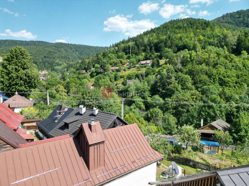 Ein Blick auf ein Einfamilienhaus in Špania Dolina, umgeben von wunderschöner Natur und Bergen.