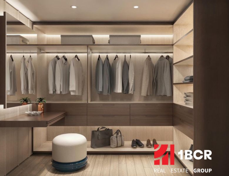Ein Kleiderschrank in einer 2-Zimmer-Wohnung mit Holzboden und dezenter Beleuchtung.