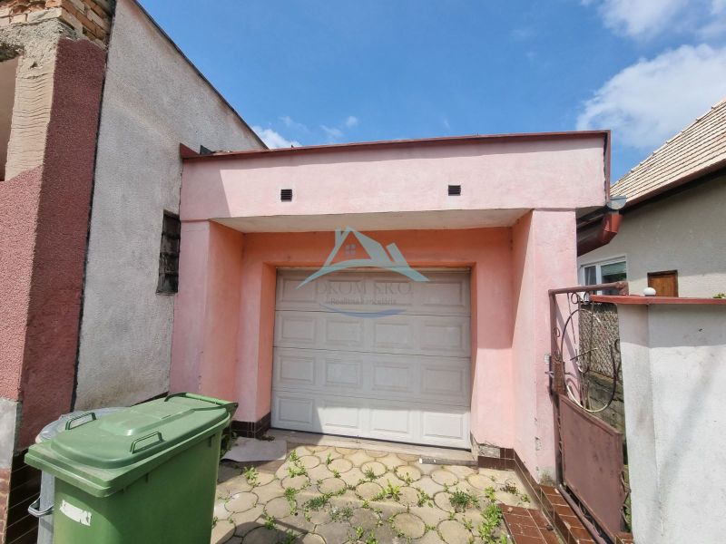 Einfamilienhaus in der Šípošova-Straße in Šahy mit Garage und Abfalltonnen.