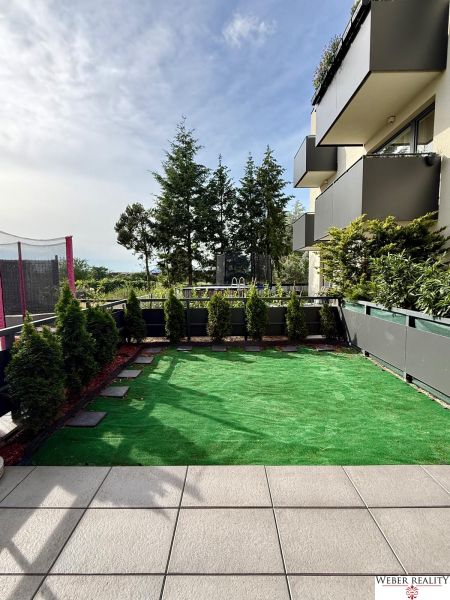 Ein Garten mit Kunstrasen in einer 2-Zimmer-Wohnung in der Broskyňová-Straße in Rovinka.