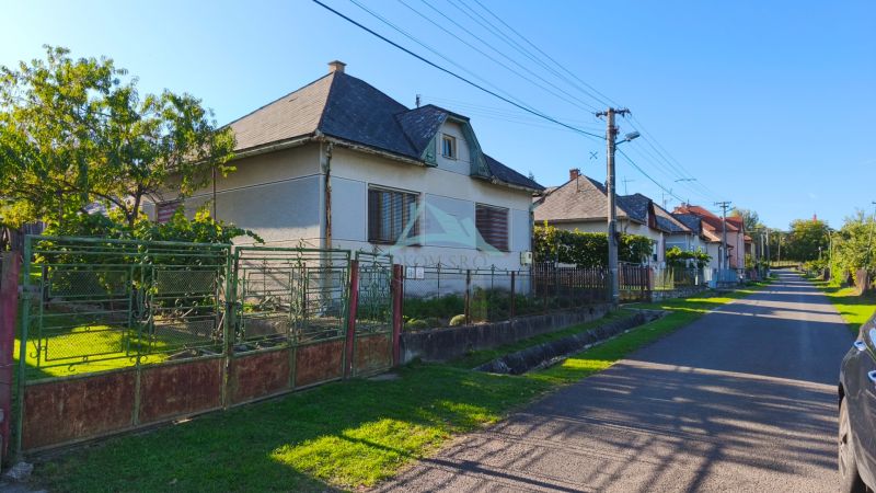 Ein Einfamilienhaus in Čebovce mit Garten und einem unkonventionellen Tor in einer ruhigen Straße.