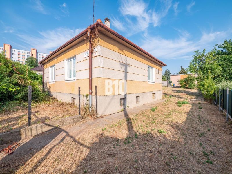 Ein Einfamilienhaus in Nitra mit einer grasbewachsenen Umgebung, daneben führt ein schmaler Weg.