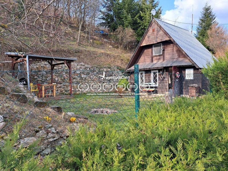 Eine Hütte mit Holzelementen im Dorf Dolné Orešany, in der Straße Dolné Orešany, umgeben von Natur.