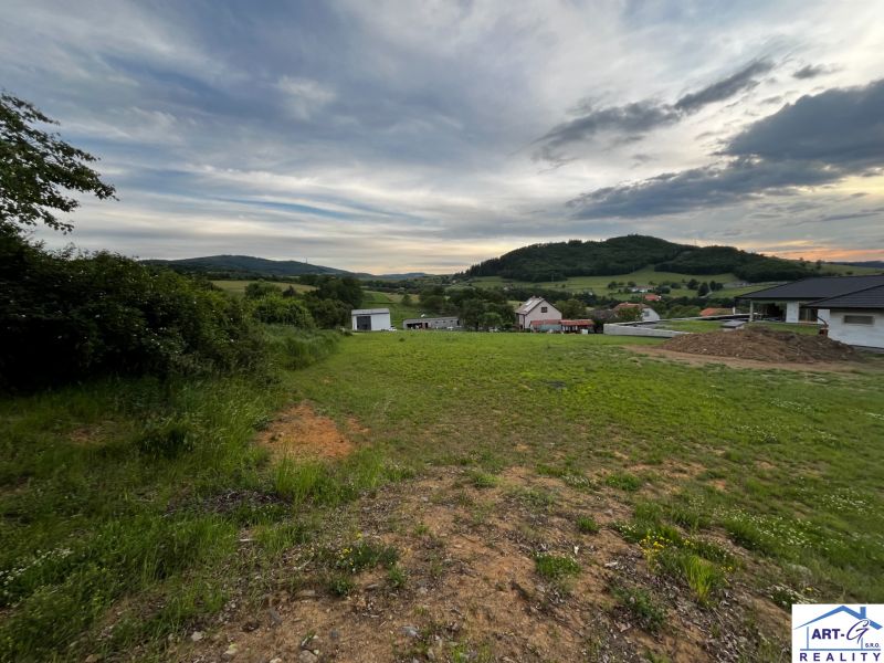 Grünflächen und hügelige Landschaft im Hintergrund der Wohngebiete in Stožok.