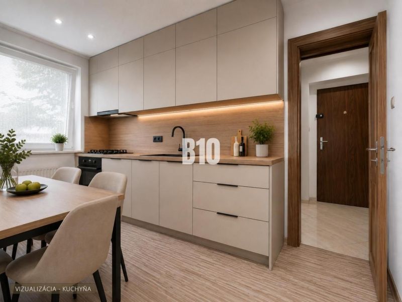 Helle Küche mit Holzboden und einfachem Tisch in einer 3-Zimmer-Wohnung.