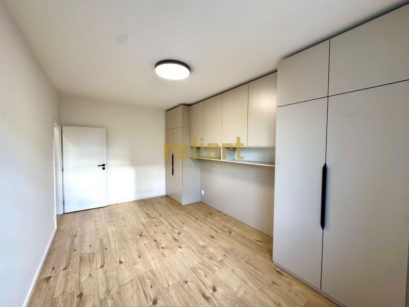 Ein Zimmer in einer 3-Zimmer-Wohnung mit Holzboden und Einbauschrank.