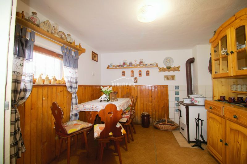 Innenraum einer Hütte mit rustikalen Möbeln und Dekorationen, Boden mit Holzdekor.