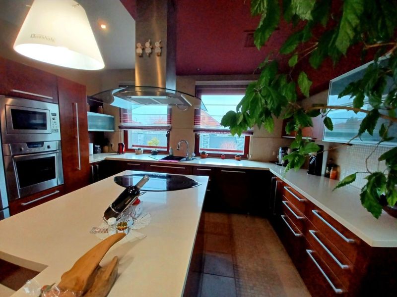 Küche in einem Einfamilienhaus mit modernen Geräten und einer zentralen Insel.