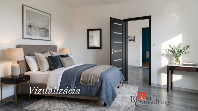 Schlafzimmer mit Bett, Teppich, Lampen und Holzboden in einer Einzimmerwohnung.