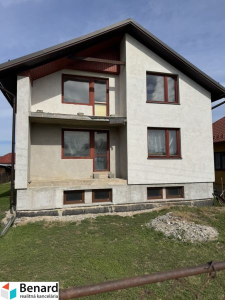 Ein Einfamilienhaus in Plavnica mit einer einfachen Fassade und neuen Fenstern, mit einem grasbewachsenen Grundstück.